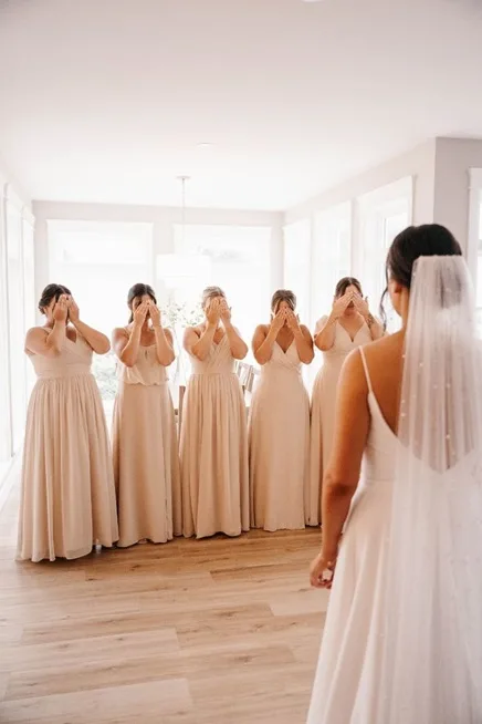 Have your friends close their eyes and wait in another room while you make an entry, all dressed up.