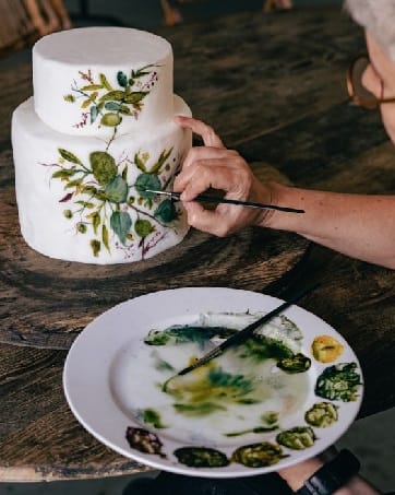 Hand-painted cakes bring an artistic touch to wedding celebrations.