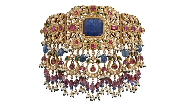 The necklace beautifully blends the gemstones with embroidered bridal attire.