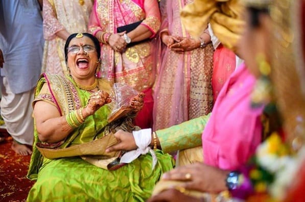 Here, the groom jokingly holds the mother-in-law’s pallu and requests more gifts.
