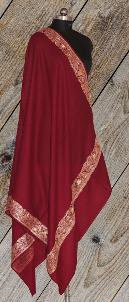 It is a form of embroidery where gold or silver threads create intricate patterns around the edges of the shawl.