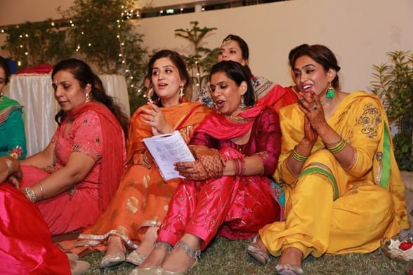 Traditionally, women gathered around with dholkis and clapped along as they sang the songs.